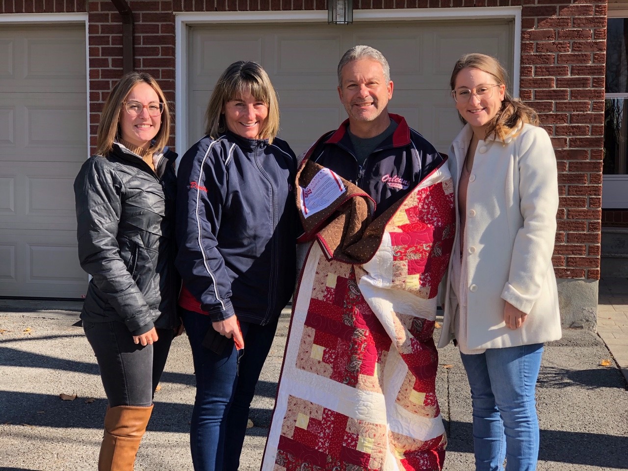 Recipient of a Quilt of Valour, CPO1(Ret’d) Sylvain Bolduc, accompanied by daughter Bianca (far left), wife Denise (his left) and daughter Jessika (his right).